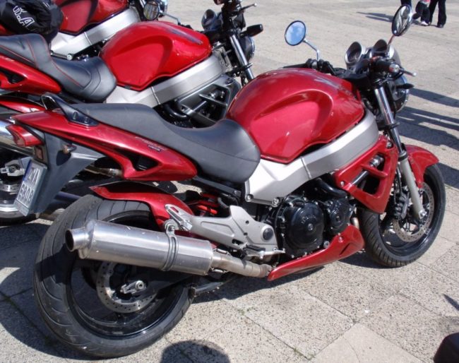 Вид сбоку мотоцикла Honda X11 серебристо-малинового окраса с хромированным глушителем
