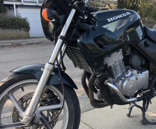 Телескопическая вилка обычного типа на мотоцикле Honda CB 500 черного цвета